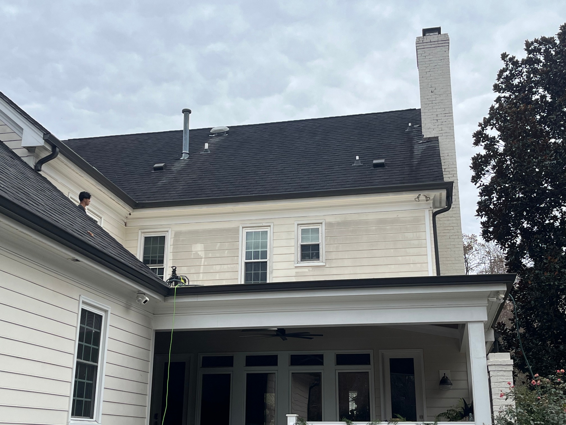 Good Fellas technicians cleaning upper-story windows at a Raleigh home