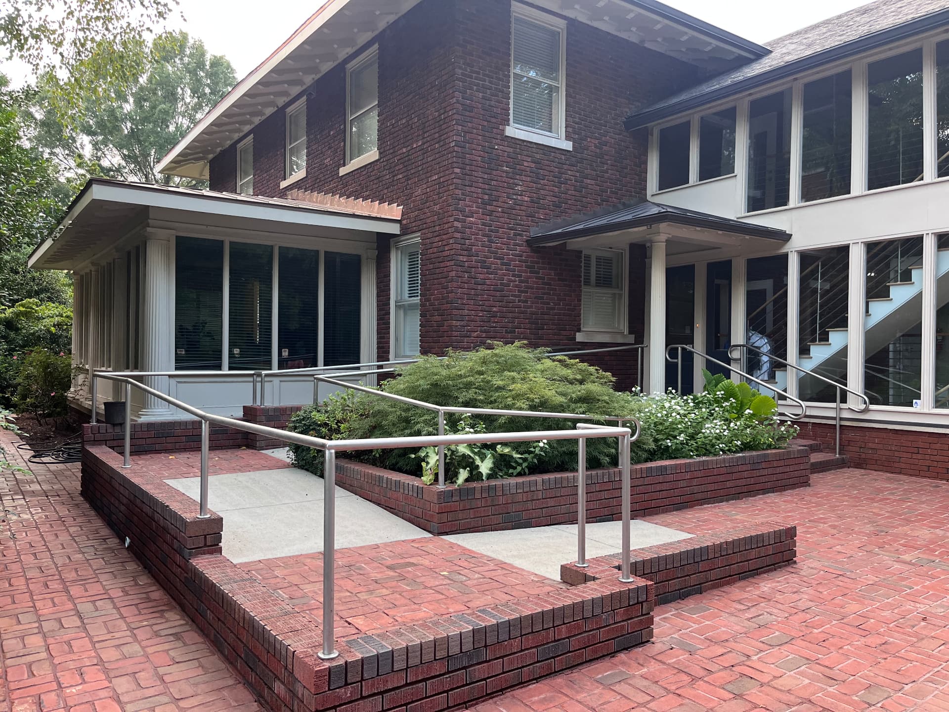 Clean, well-maintained brick commercial building with brick patio and accessibility ramp in Raleigh